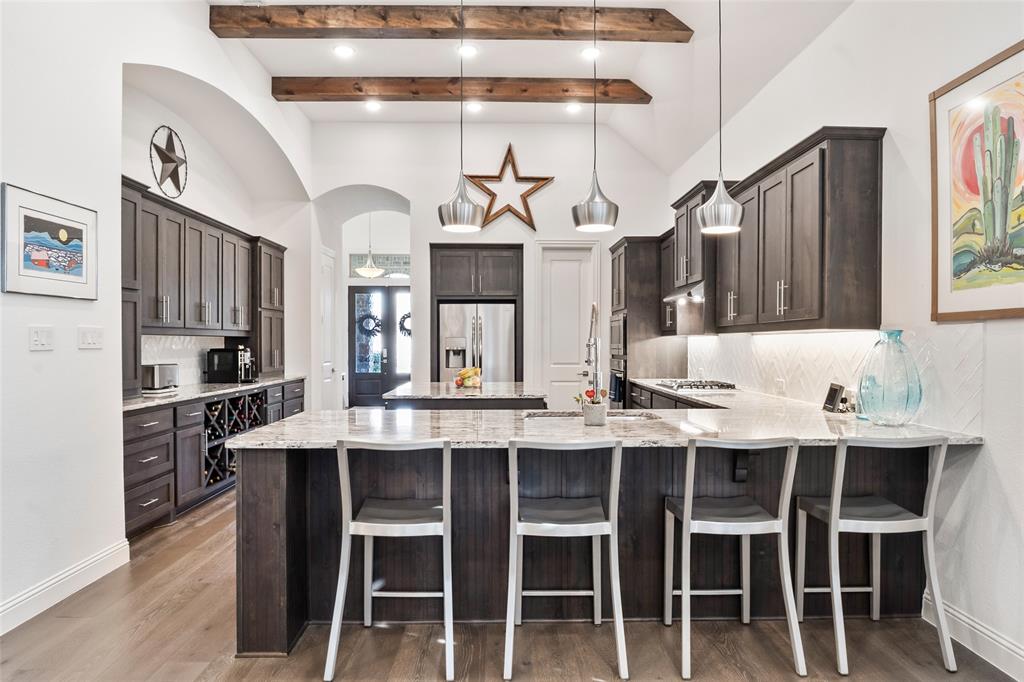 2109 Georgetown Boulevard Prosper, TX 75078 - Photo 7 of 40 a kitchen with cabinets and chairs