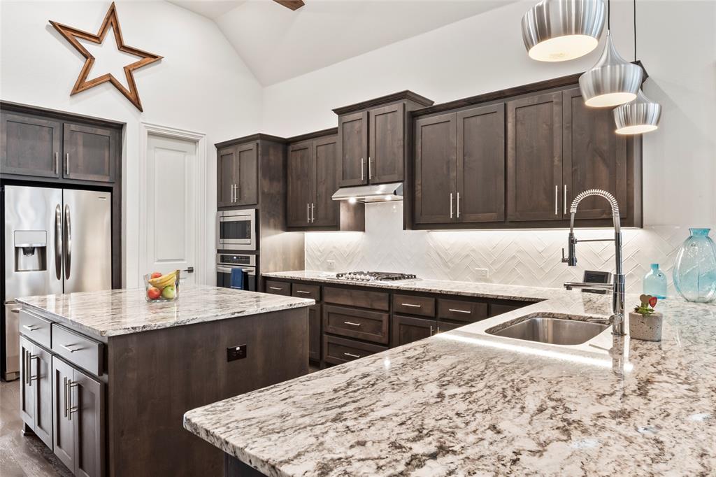 2109 Georgetown Boulevard Prosper, TX 75078 - Photo 8 of 40 a kitchen with stainless steel appliances granite countertop a sink stove and refrigerator