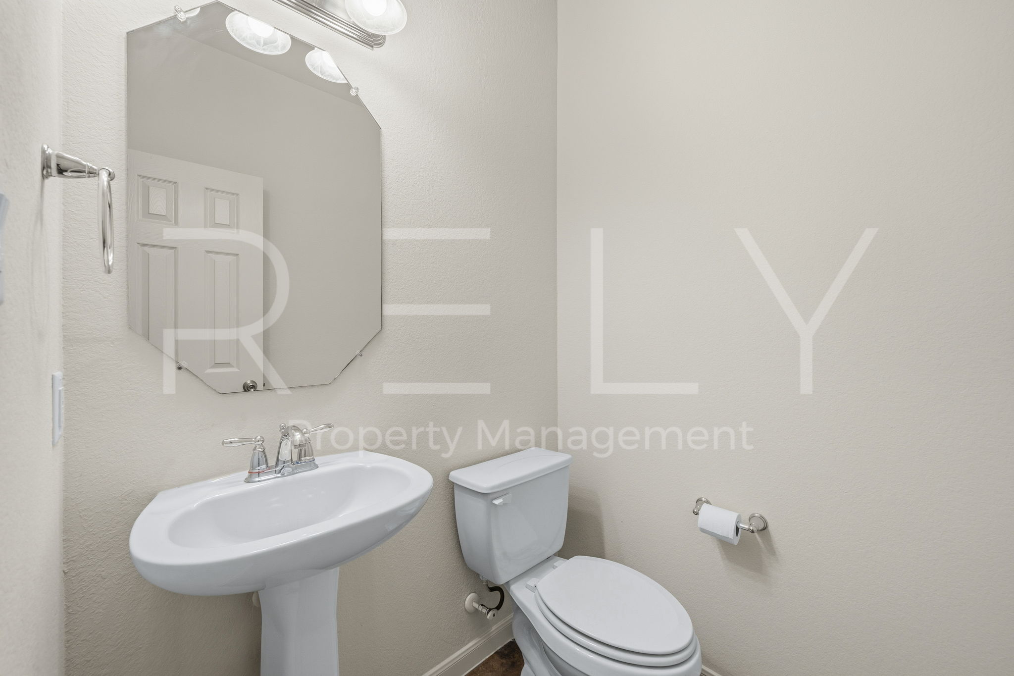 1405 Sunny Meadows Loop Georgetown, TX 78626 - Photo 14 of 40 A well-appointed powder room with a sleek pedestal sink and elegant octagonal mirror.