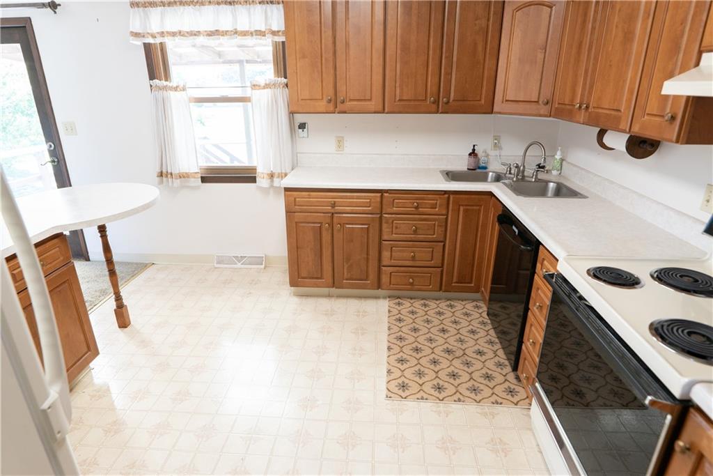 3565 Tuscarawas Road Beaver, PA 15009 - Photo 4 of 37 a kitchen with a sink a stove cabinets and wooden floor