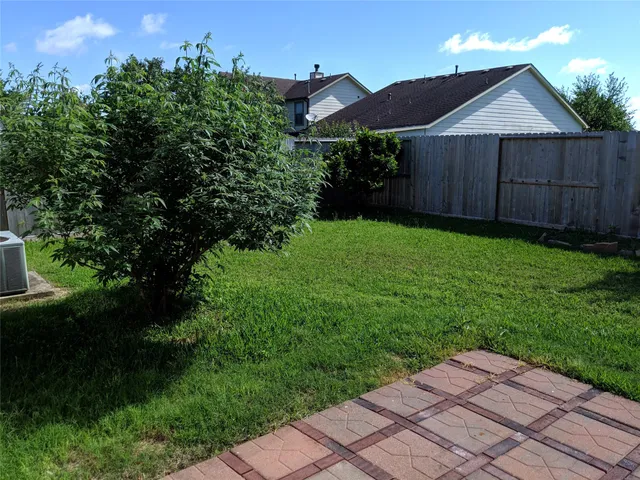 a backyard of a house with lots of green space