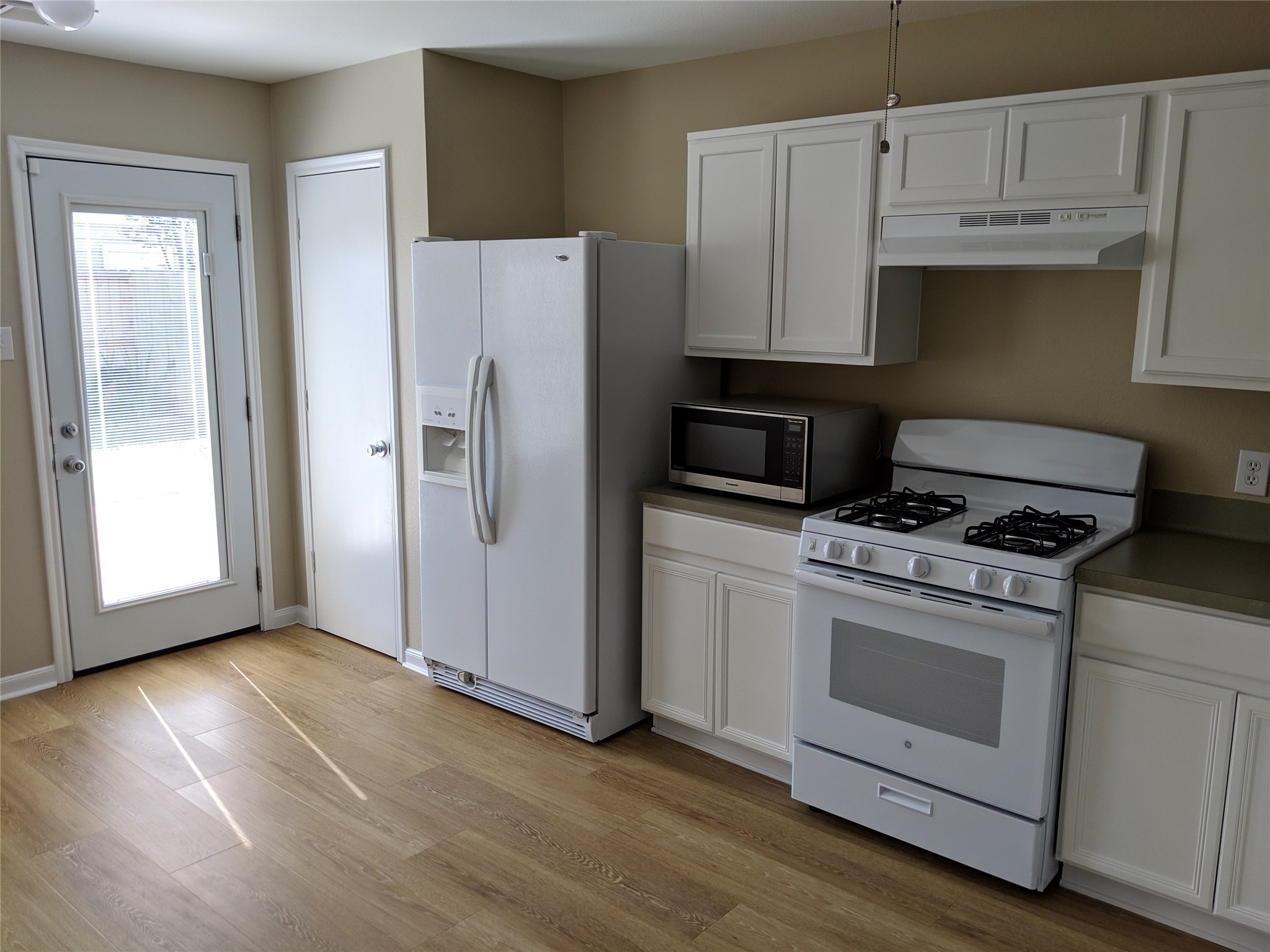 21210 Shadow River Lane Spring, TX 77379 - Photo 5 of 21 a kitchen with granite countertop white cabinets and white appliances