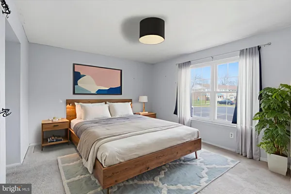 a bedroom with a bed and a potted plant