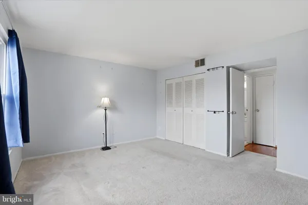a view of a room with a chandelier fan and closet
