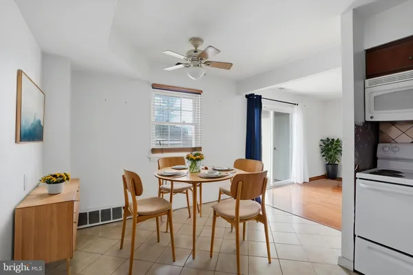 a dining room with furniture and window