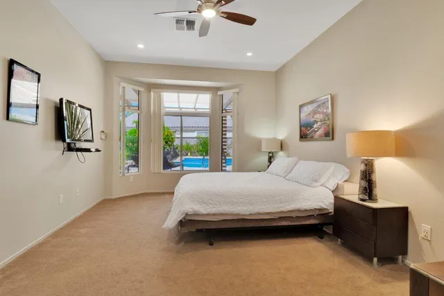a bedroom with a bed couch and window