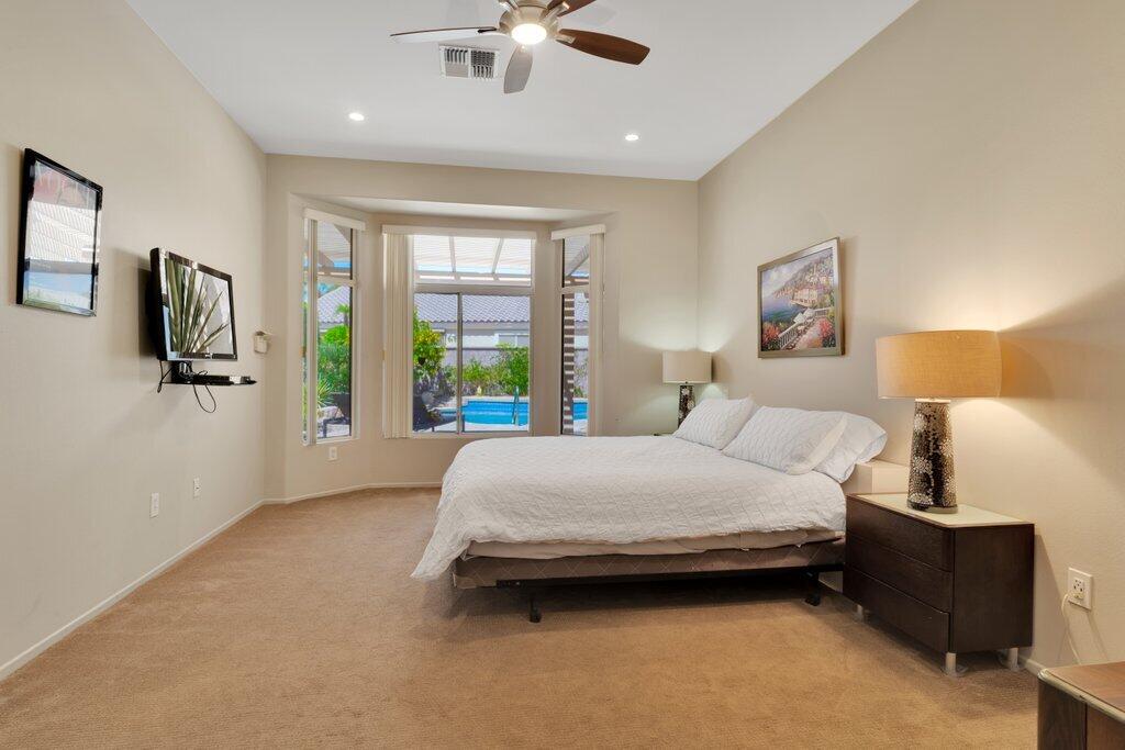 39357 Mirage Circle Palm Desert, CA 92211 - Photo 11 of 32 a bedroom with a bed couch and window