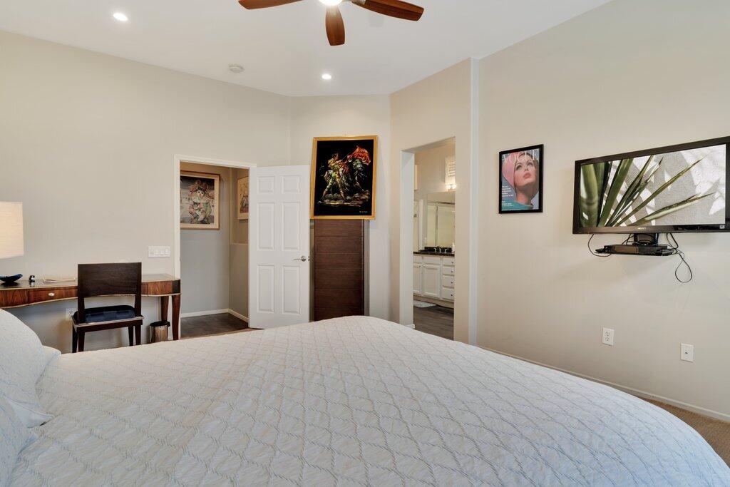 39357 Mirage Circle Palm Desert, CA 92211 - Photo 12 of 32 a bedroom with a large bed and a flat screen tv