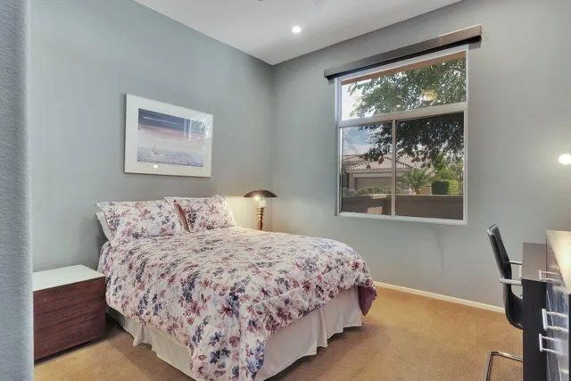 a bedroom with a large bed and a window