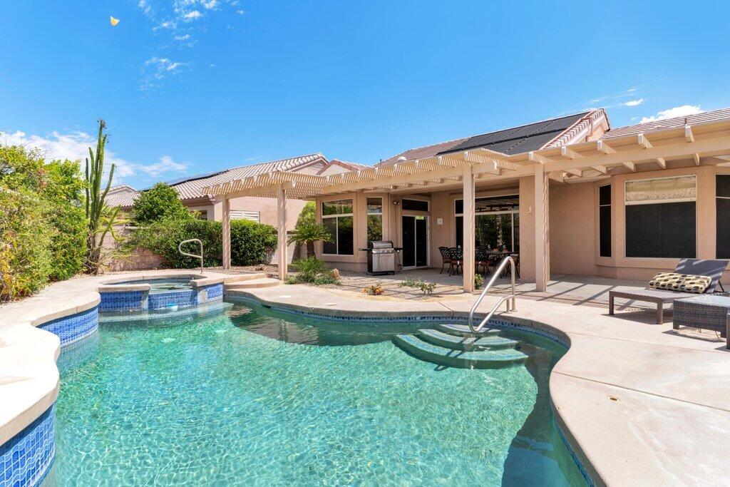 39357 Mirage Circle Palm Desert, CA 92211 - Photo 24 of 32 a view of a house with swimming pool and a yard