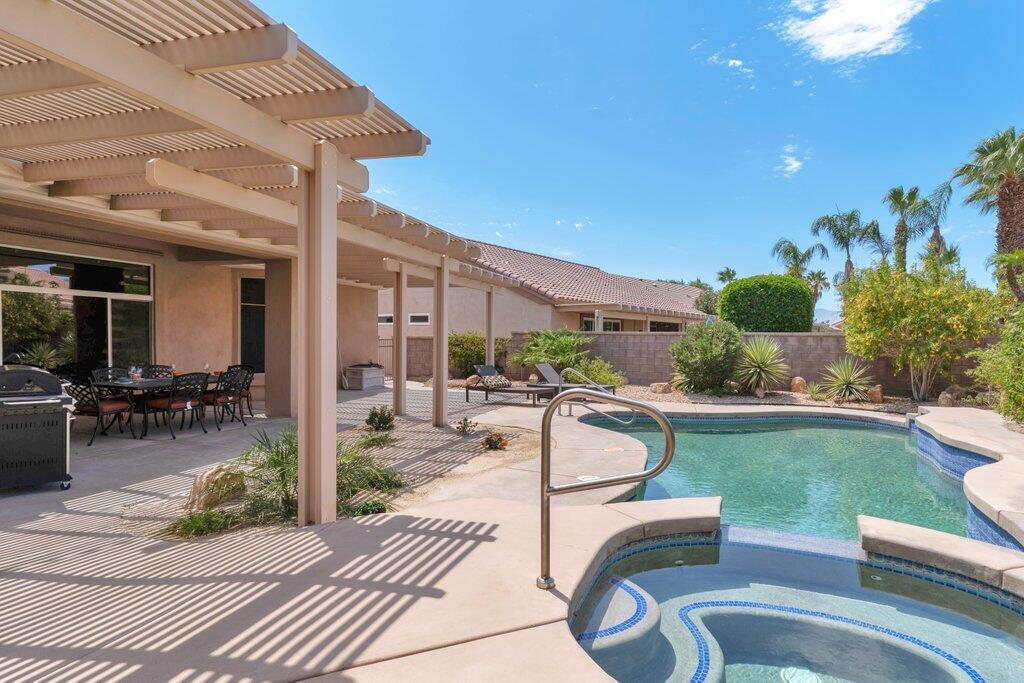 39357 Mirage Circle Palm Desert, CA 92211 - Photo 25 of 32 a swimming pool with outdoor seating and yard