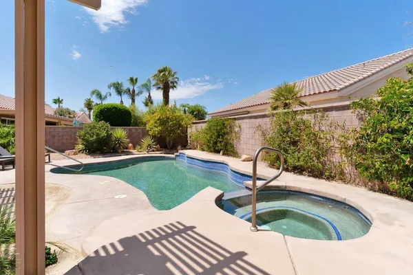 a view of a swimming pool with a patio