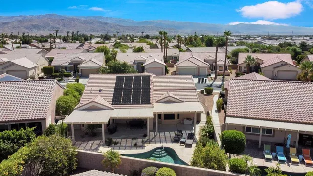 an aerial view of a house with a yard