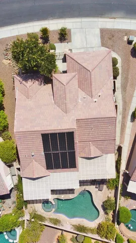 an aerial view of a house with a yard