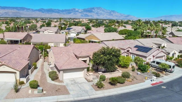 an aerial view of residential houses with outdoor space