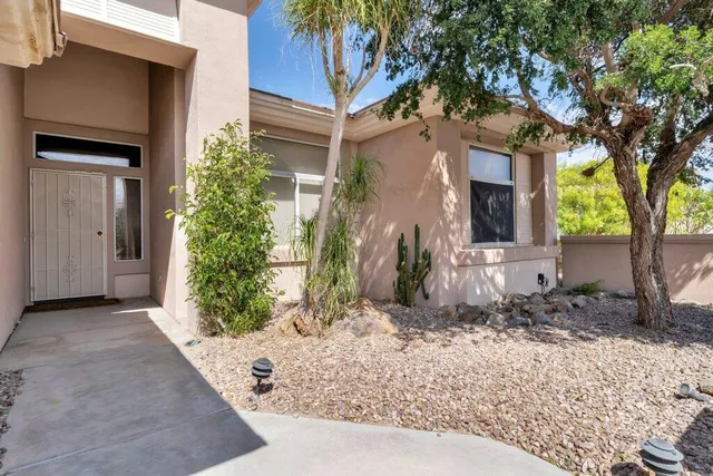 a front view of a house with a yard garage and outdoor seating