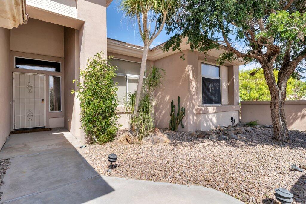 39357 Mirage Circle Palm Desert, CA 92211 - Photo 3 of 32 a front view of a house with a yard garage and outdoor seating