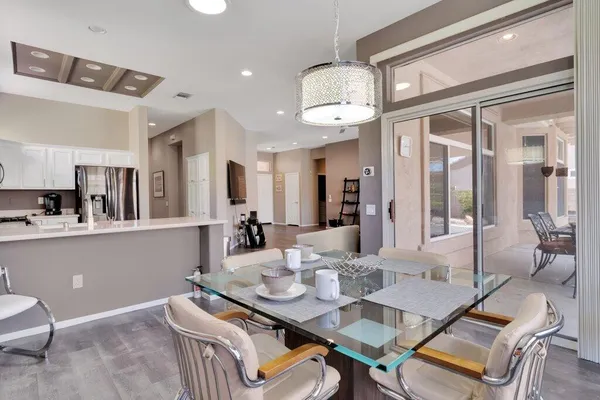 a view of a dining room with furniture and a chandelier