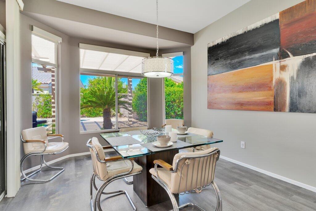 39357 Mirage Circle Palm Desert, CA 92211 - Photo 8 of 32 a dining room with furniture large windows and wooden floor