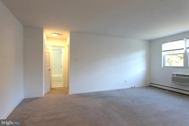 a view of an empty room and a window