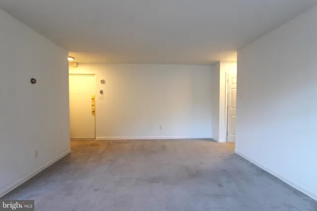 a view of an empty room and a window