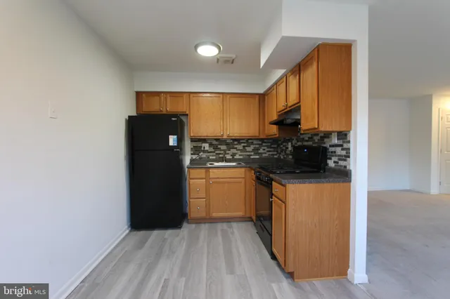 a kitchen with a refrigerator and a stove