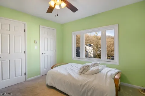 a bedroom with a bed and a large window