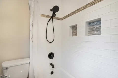 a bathroom with a shower and a toilet