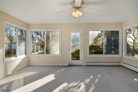 an empty room with windows and outdoor view