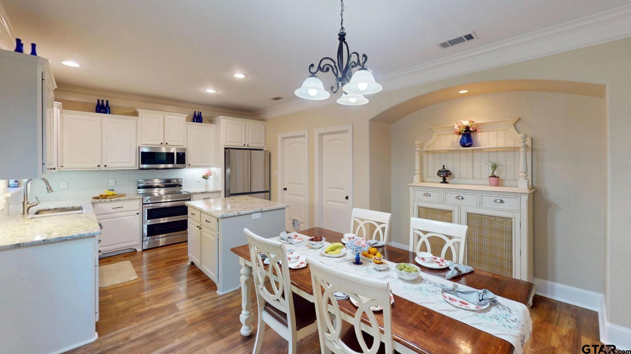 18488 Bluebird Circle Flint, TX 75762 - Photo 11 of 47 a kitchen with kitchen island granite countertop stainless steel appliances a dining table and chairs in it