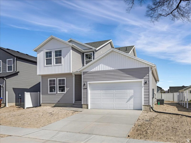 1554 Pheasant Road Eagle Mountain, UT 84005 - Photo 3 of 29 Contemporary residence featuring gray horizontal siding and white vertical siding accents