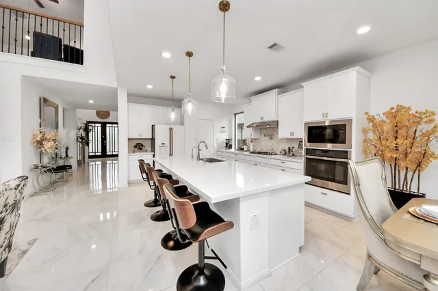 a kitchen with a sink stainless steel appliances and cabinets