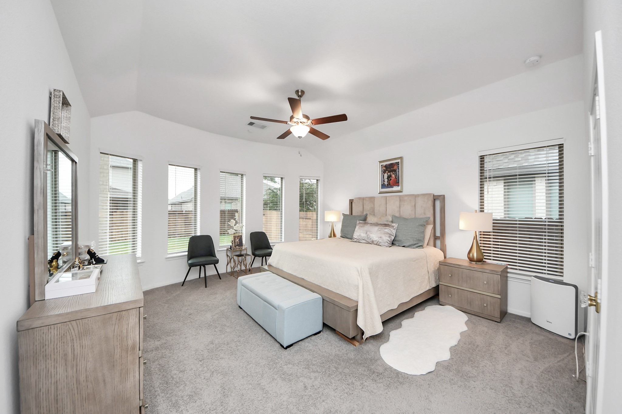 14948 Galileo Gates Drive Conroe, TX 77302 - Photo 17 of 30 a spacious bedroom with a bed couch and large windows