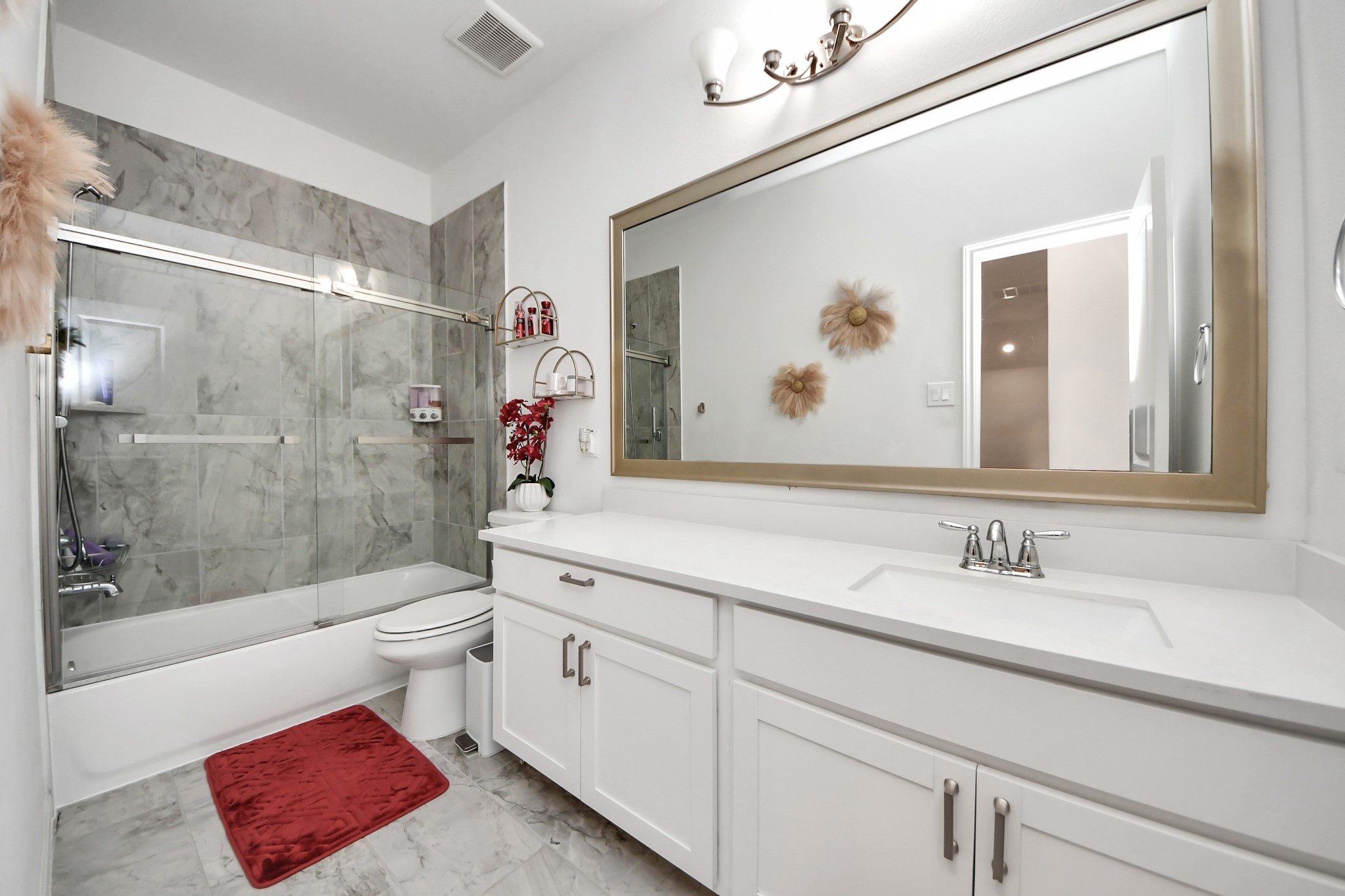 14948 Galileo Gates Drive Conroe, TX 77302 - Photo 25 of 30 a bathroom with a sink a toilet and shower