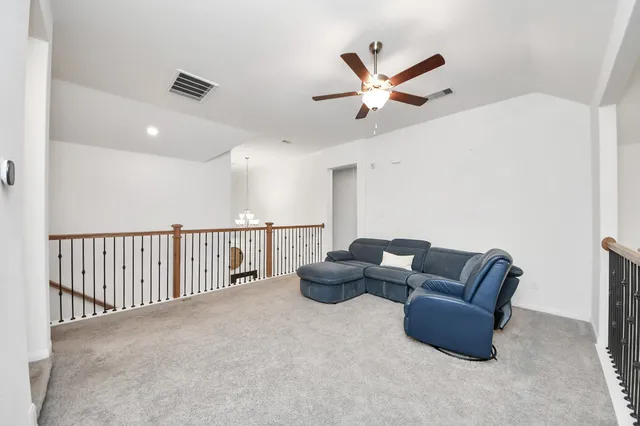 a view of a dining room with furniture a chandelier and wooden floor