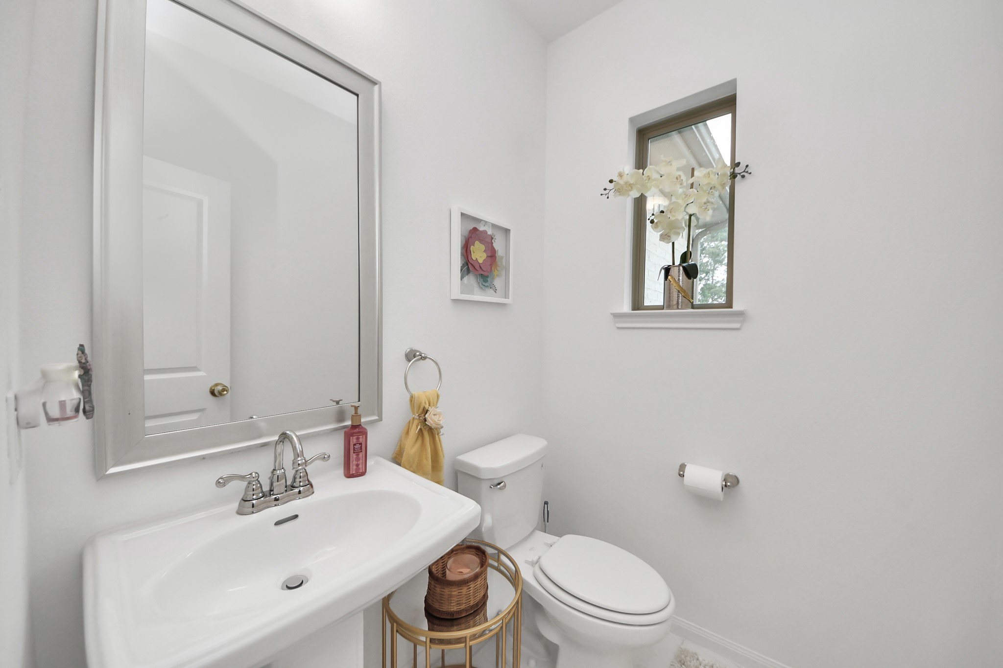 14948 Galileo Gates Drive Conroe, TX 77302 - Photo 3 of 30 a bathroom with a toilet a sink and mirror