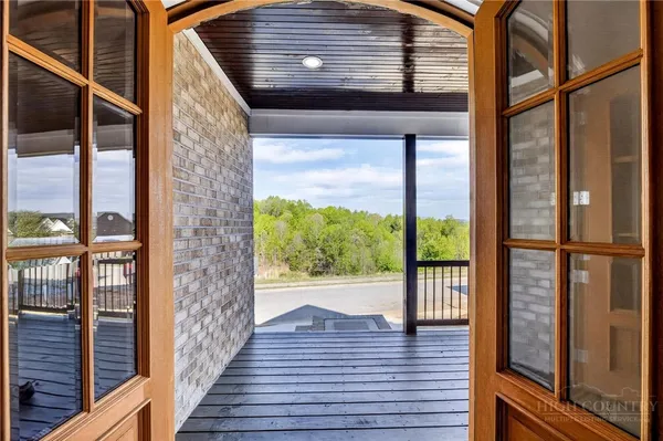 a view of a balcony with wooden floor