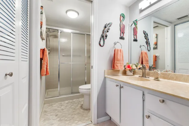 a bedroom with a bed couches chair and a large window