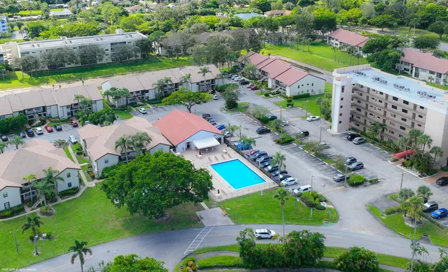 a swimming pool with outdoor seating and yard