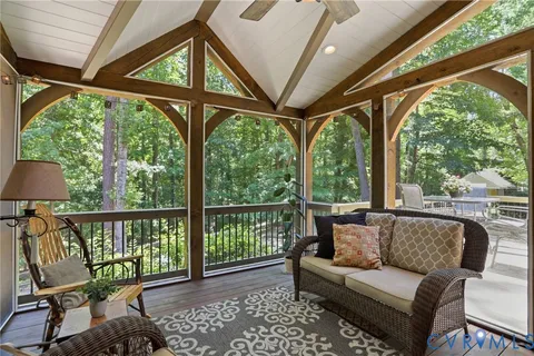 a living room with furniture a bed and a large window