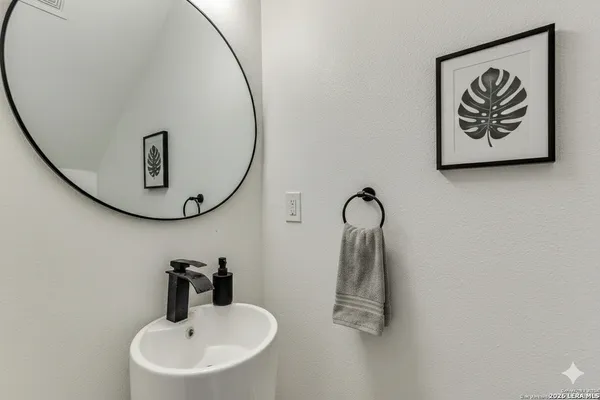 a bathroom with a sink and mirror