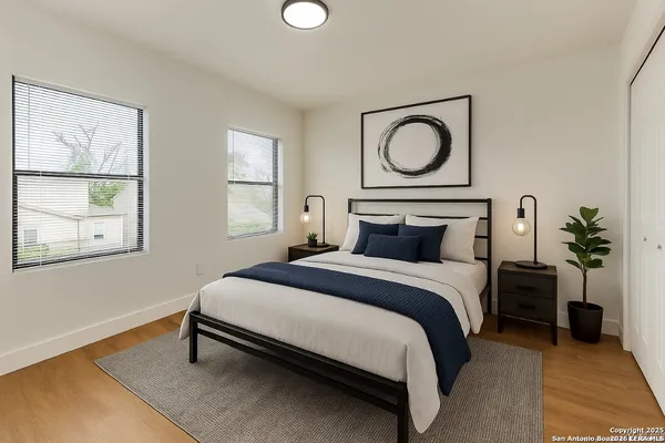 a bedroom with a bed and a painting on the wall