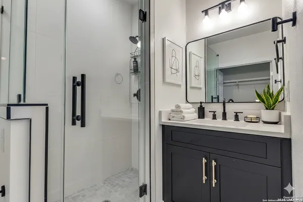 a bathroom with a sink a mirror and vanity