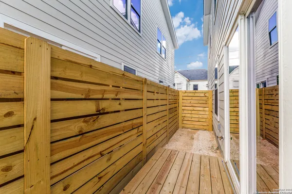 a view of a balcony with wooden floor and door