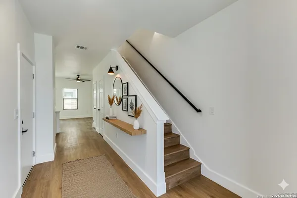 a view of entryway and hall with wooden floor