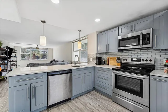 a kitchen with a sink stove and microwave