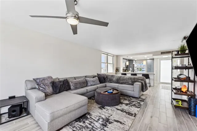 a living room with furniture and a flat screen tv with wooden floor