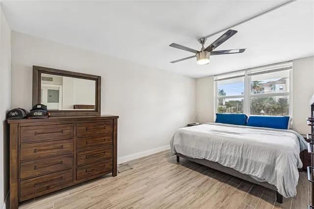 a bedroom with a bed and a ceiling fan