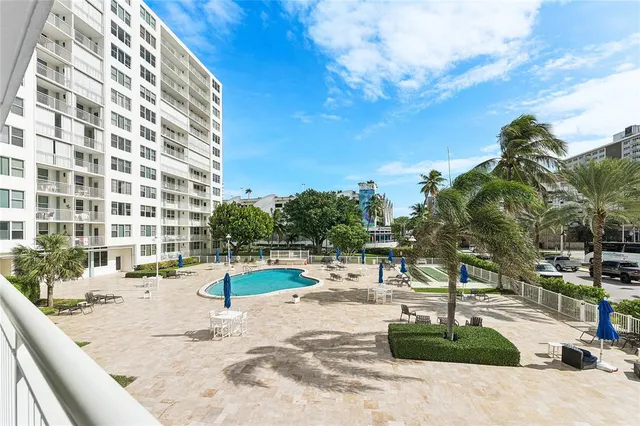 a view of a livingroom with wooden floor and windows