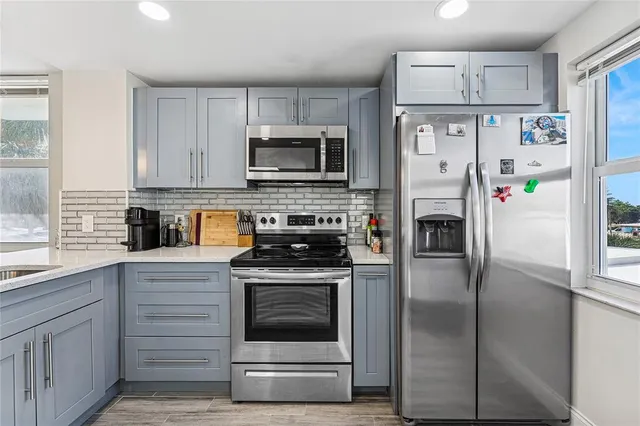 a kitchen with a refrigerator stove and sink